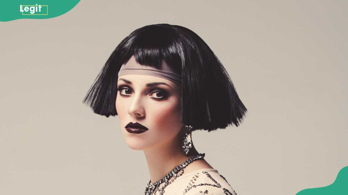 A stunning woman in 1920s style, deep kohl-lined eyes