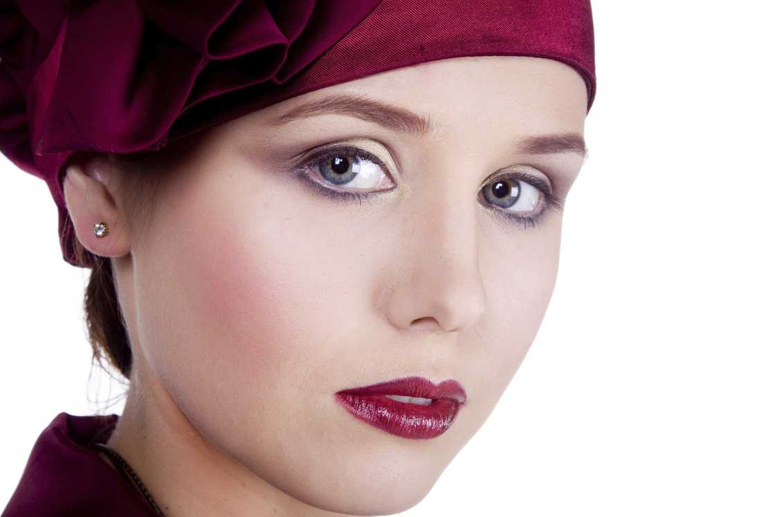 A beautiful woman in 1920s glamour, pale, matte complexion