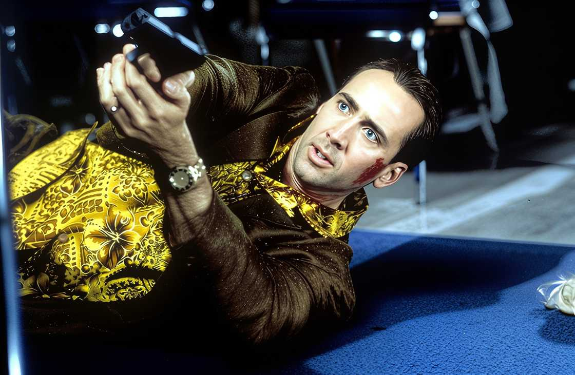 Nicolas Cage pointing a gun