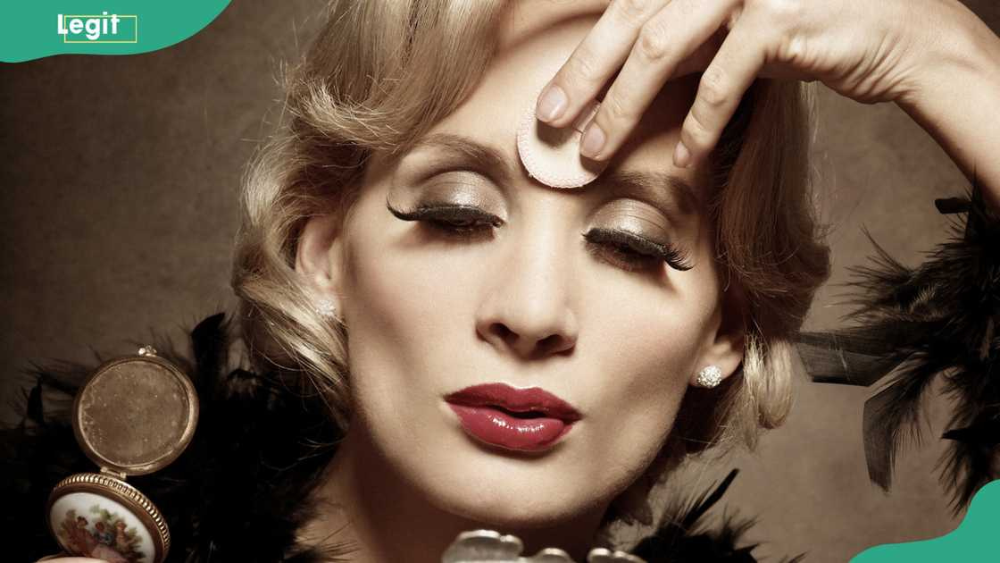 Young woman powdering her face